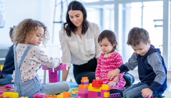 Children playing blocks with an educator