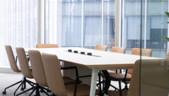 An empty meeting room with table and chairs