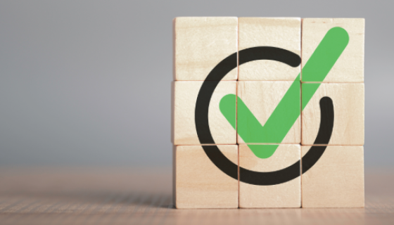 An image showing a group of blocks stacked together to show a green tick in a circle
