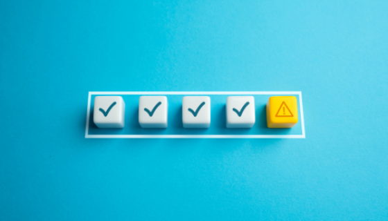 An image with a blue background showing 4 ticks and 1 hazard symbol