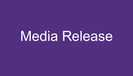 An image with a purple background and white text stating "Media Release"