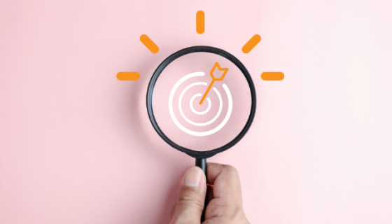 An image of a microscope on a target with a pink background. 