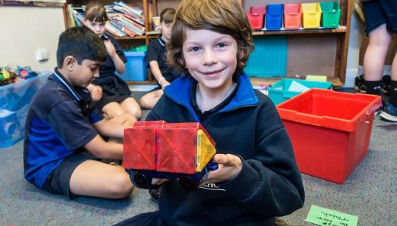 Boy playing with blocks at out of school hours care