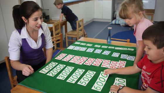 Jessica Matheson, Director of Jescott Montessori Preschool, introduces two children to the decimal system