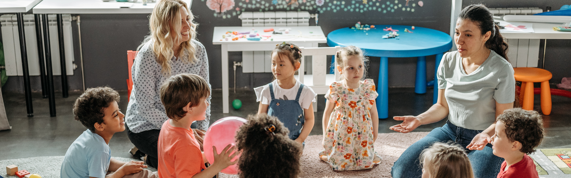 National Child Safety Review and Regulatory Changes image - children and educators playing on the floor.